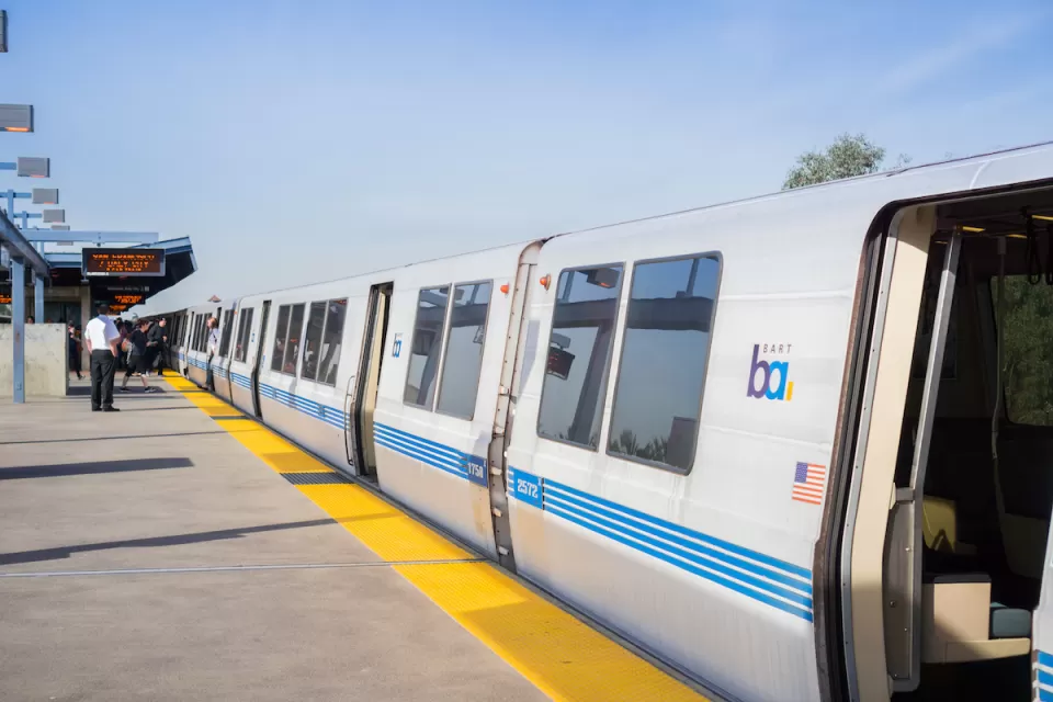BART train at outdoor above-ground station in Oakland, California